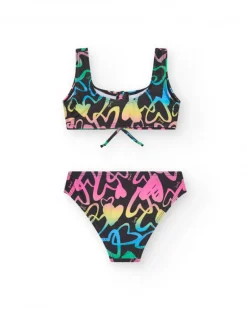 Bikini pour fille en noir avec cœurs imprimés et nœud décoratif.