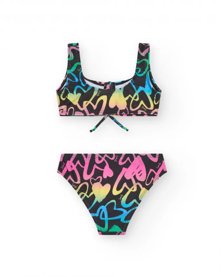 Bikini pour fille en noir avec cœurs imprimés et nœud décoratif.