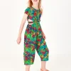 Combinaison pour fille avec imprimé tropical, boutons sur le devant et ouvertures latérales.