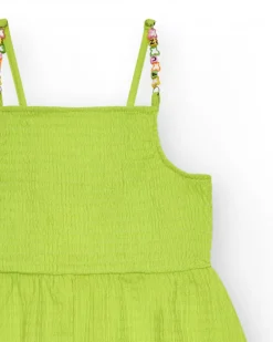 Combinaison pour fille en vert avec bretelles et détails multicolores.