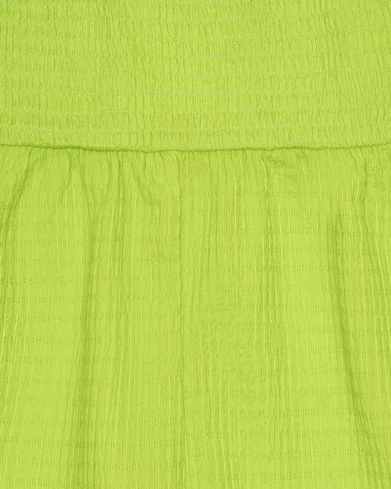 Combinaison pour fille en vert avec bretelles et détails multicolores.