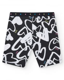 Legging cycliste pour fille en noir avec cœurs imprimés et taille décorée de clous.