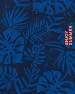 Polo pour garçon en bleu avec imprimé tropical et broderie.