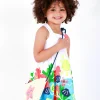 Robe blanche pour fille avec bretelles croisées et jupe fleurie