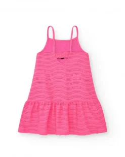 Robe pour fille en rose avec bretelles et volant.